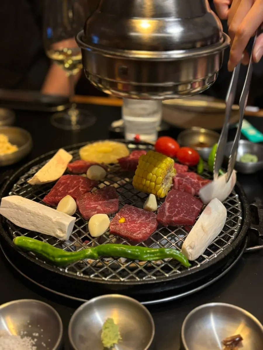 Beef grilling over charcoal