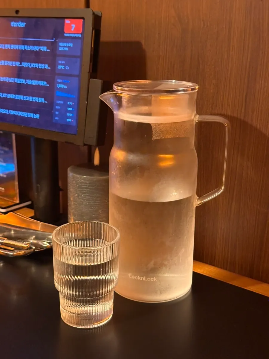 Water bottle and glasses set on a private 4-person table