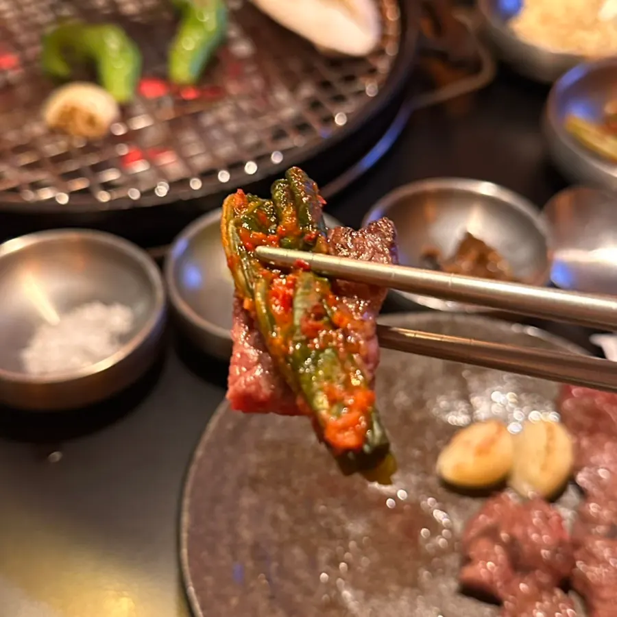 Grilled beef bite eaten with mustard leaf kimchi