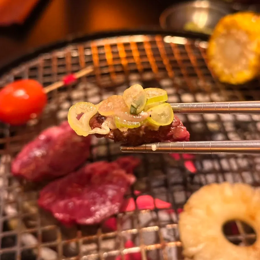 Beef bite topped with scallion salad