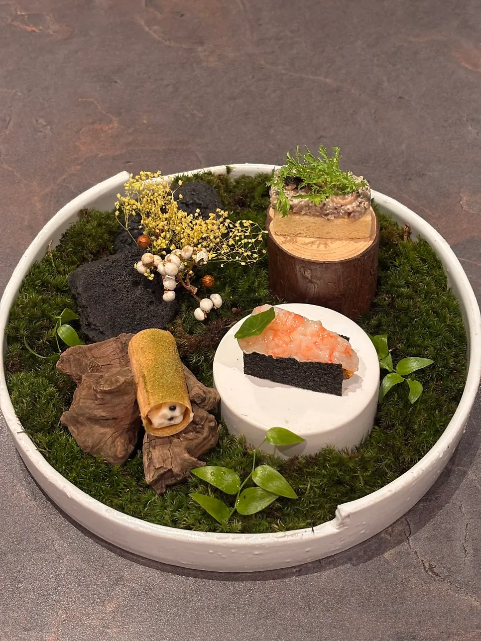 A beautifully plated dish of three bite-sized dishes