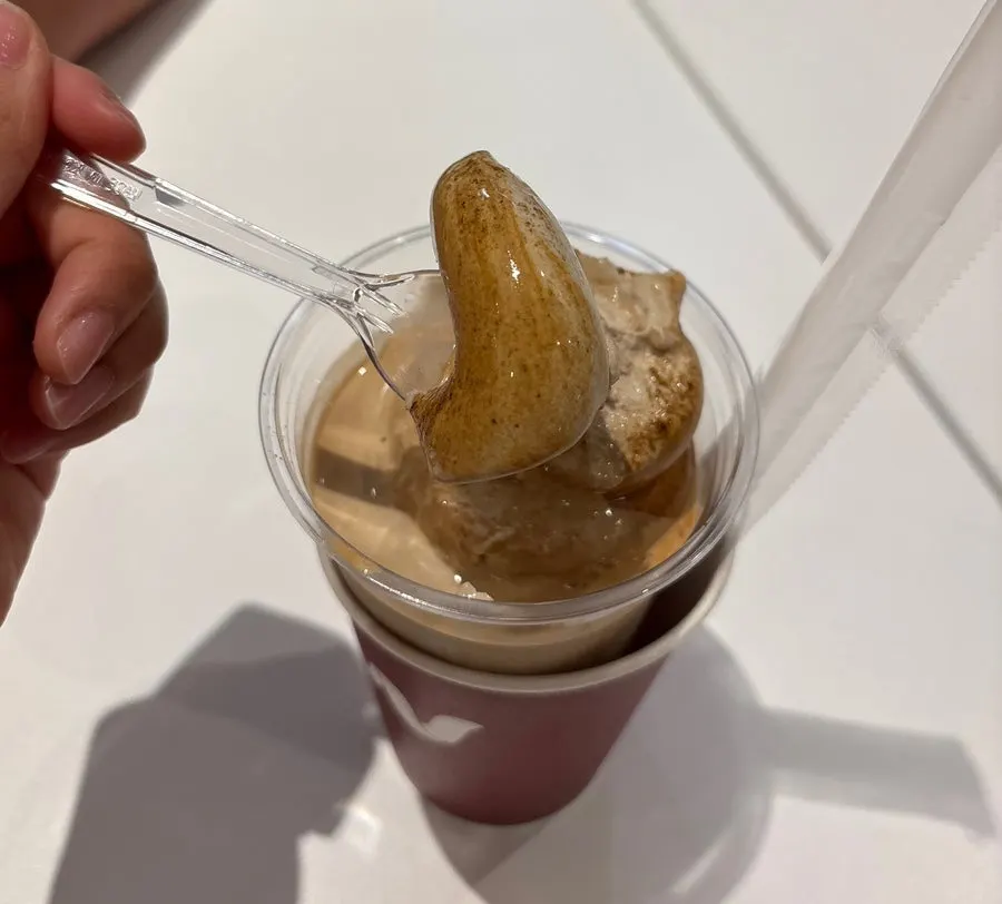 Spooning up a bite of the hojicha ice cream