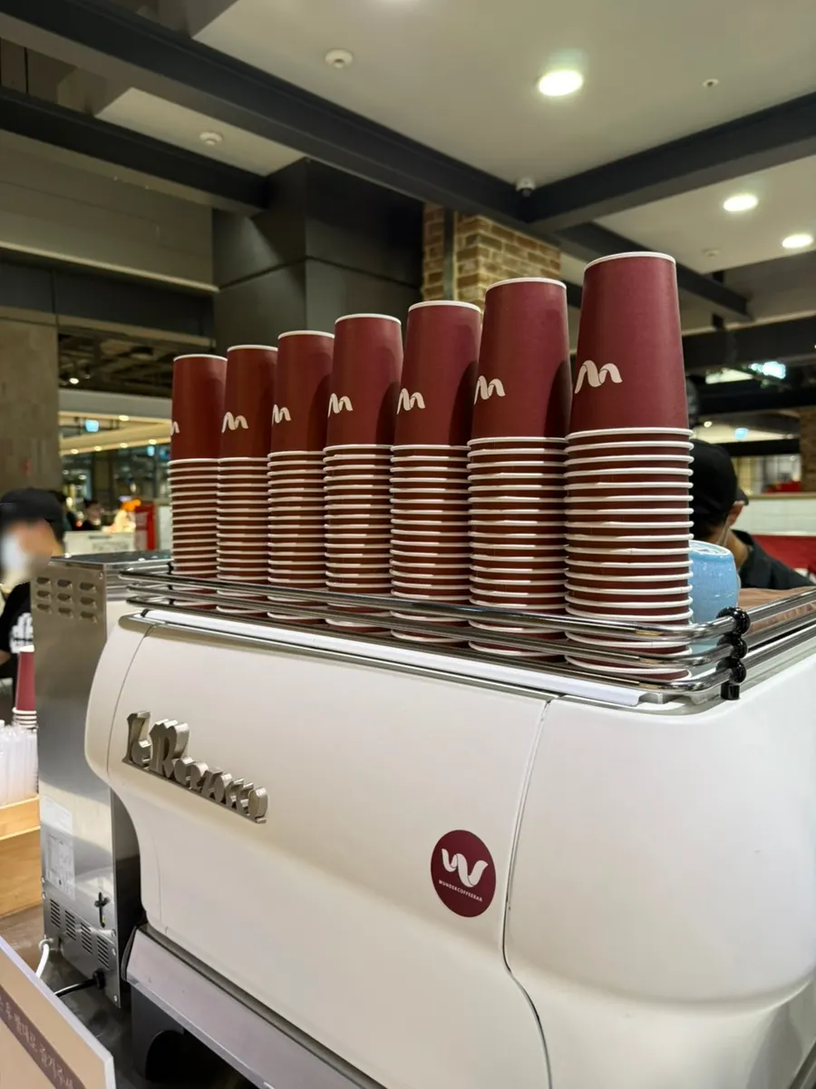 Brown cup with the Wunder Coffee Bar logo