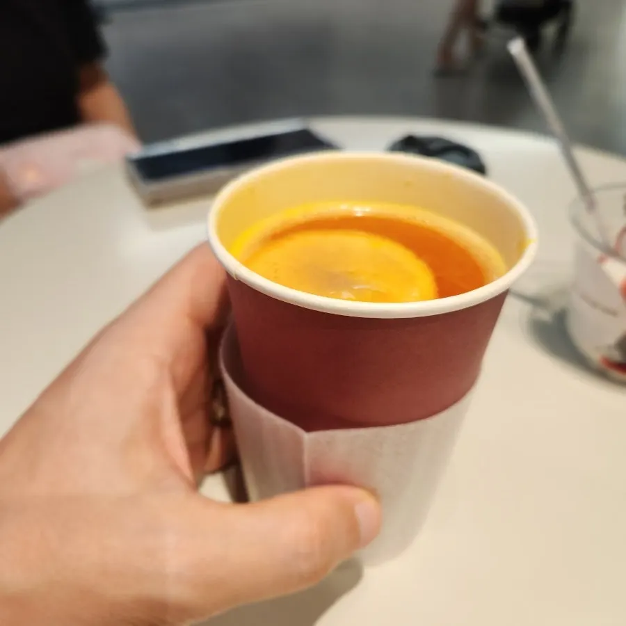 A cup of hot tangerine tea ordered at Wunder Coffee Bar