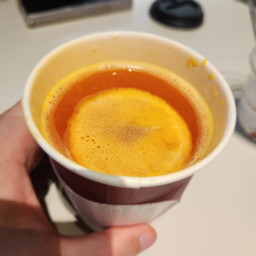 Cup of tangerine tea enjoyed during a shopping break
