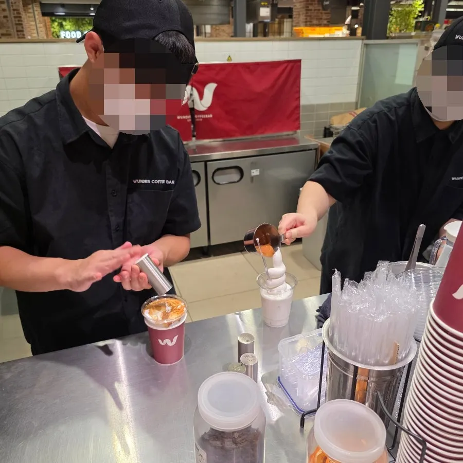 A staff member scooping soft serve ice cream at Wunder Coffee Bar