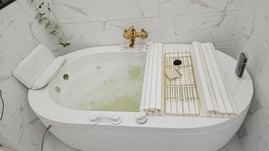 Entering the EMS spa tub after changing into workout clothes