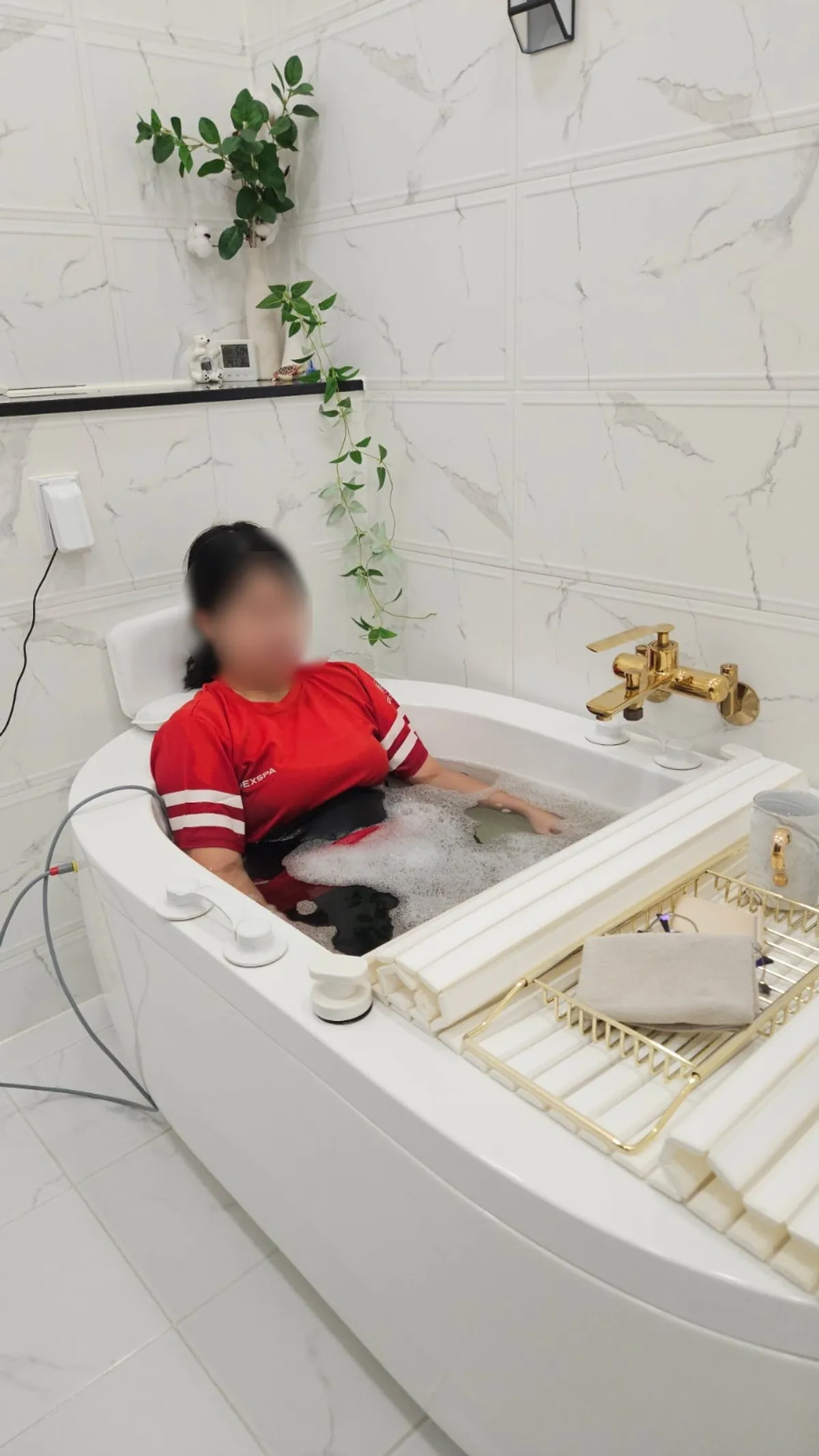 Lying in the tub receiving the 20-minute EMS spa