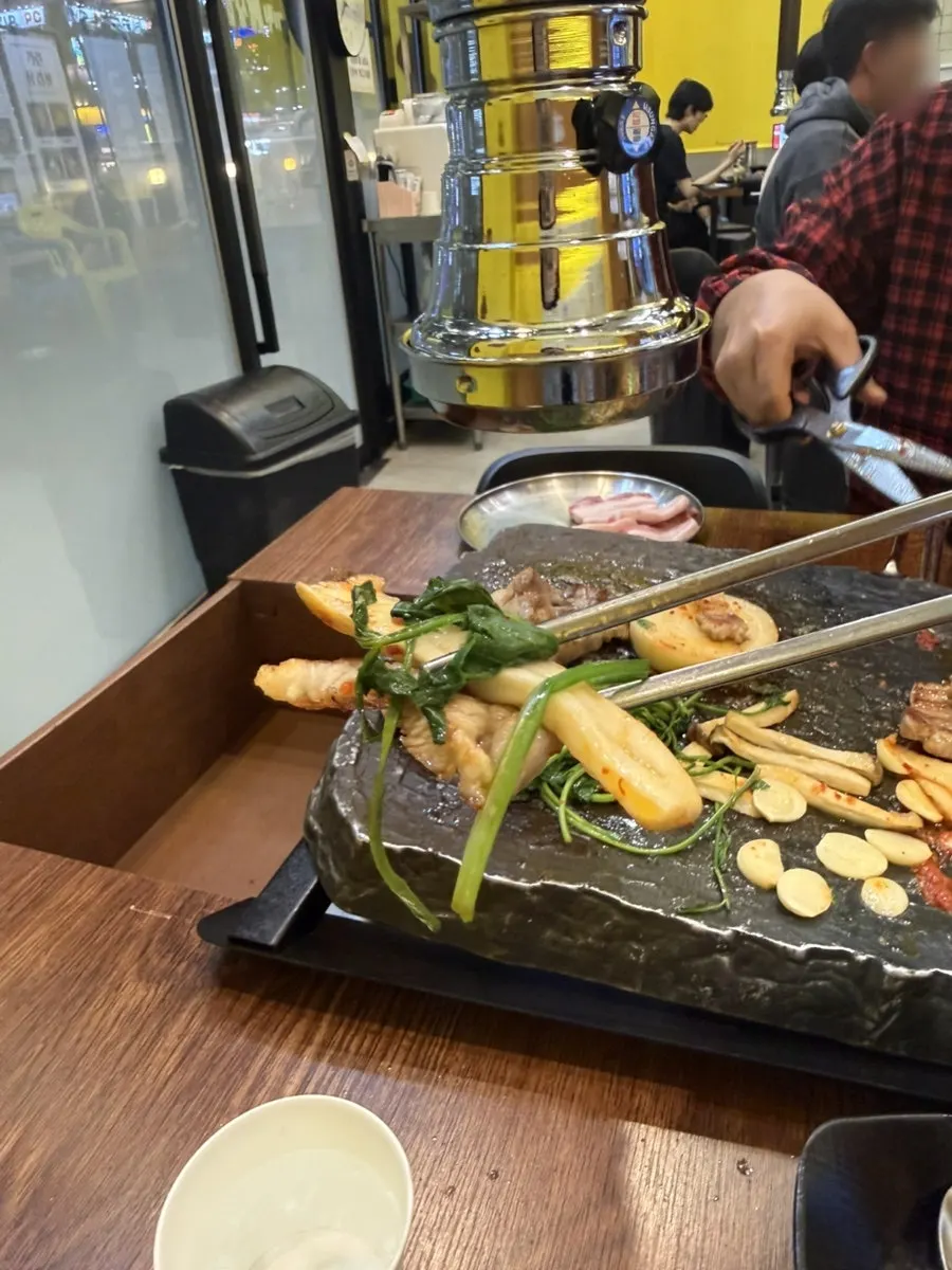 Samgyeopsal samhap topped with minari and grilled kimchi