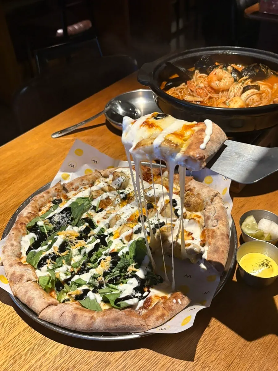 Pizza and beer enjoyed by the window