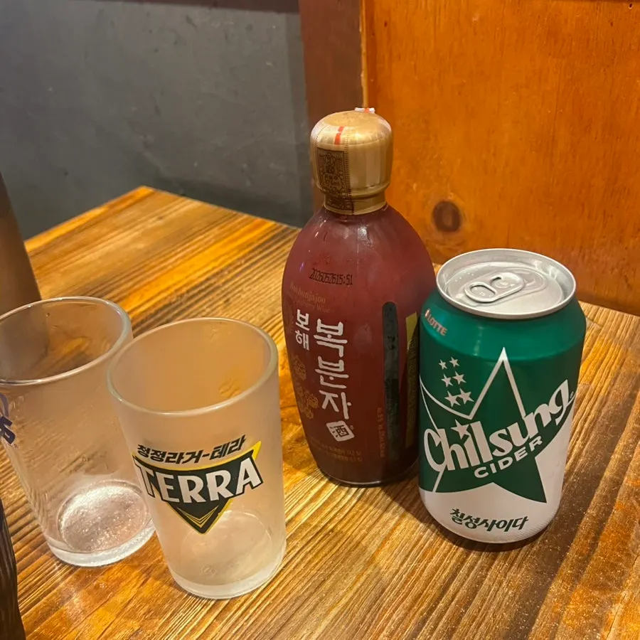 Glass of bokbunja wine mixed with soju and cider