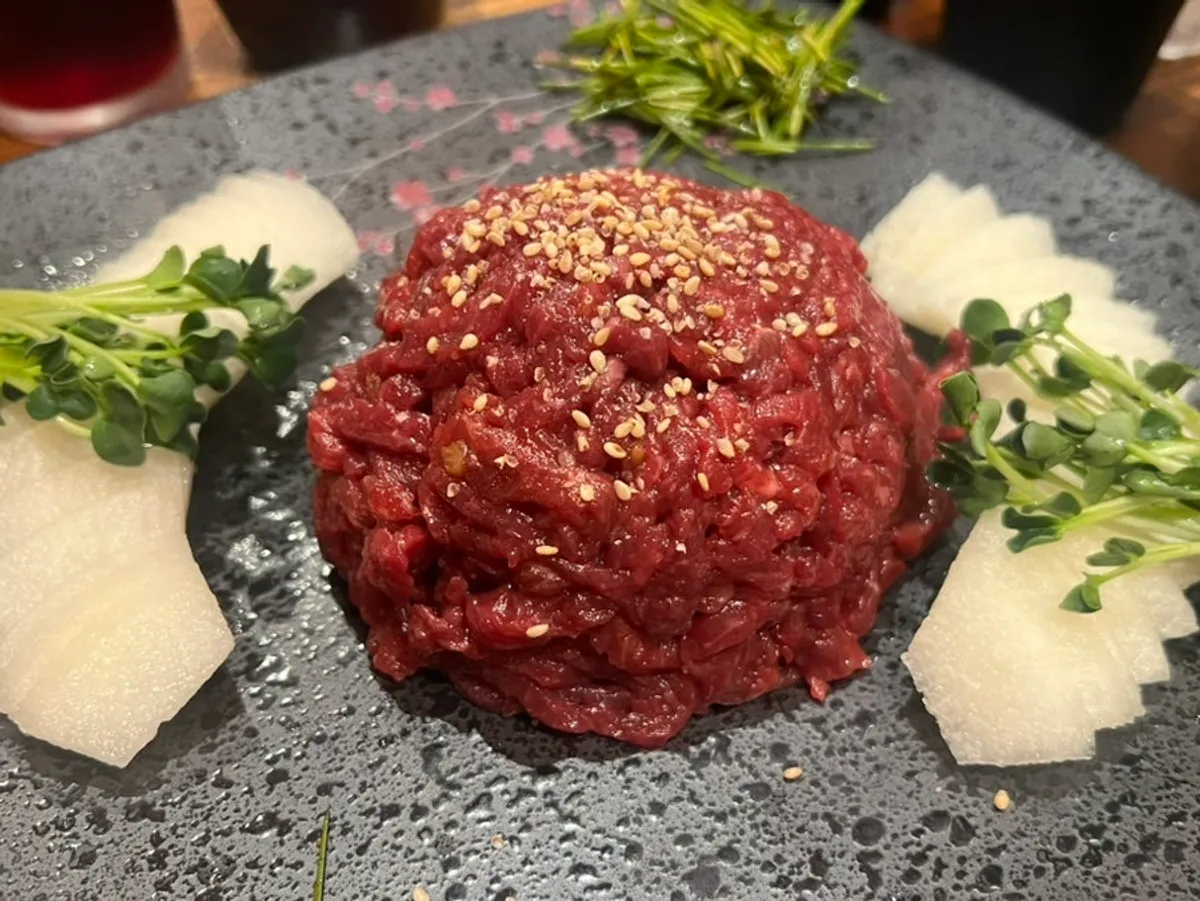 Korean beef yukhoe topped with pear and radish sprouts