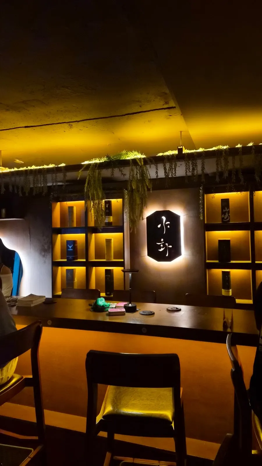 Bar counter lined with liquor bottles