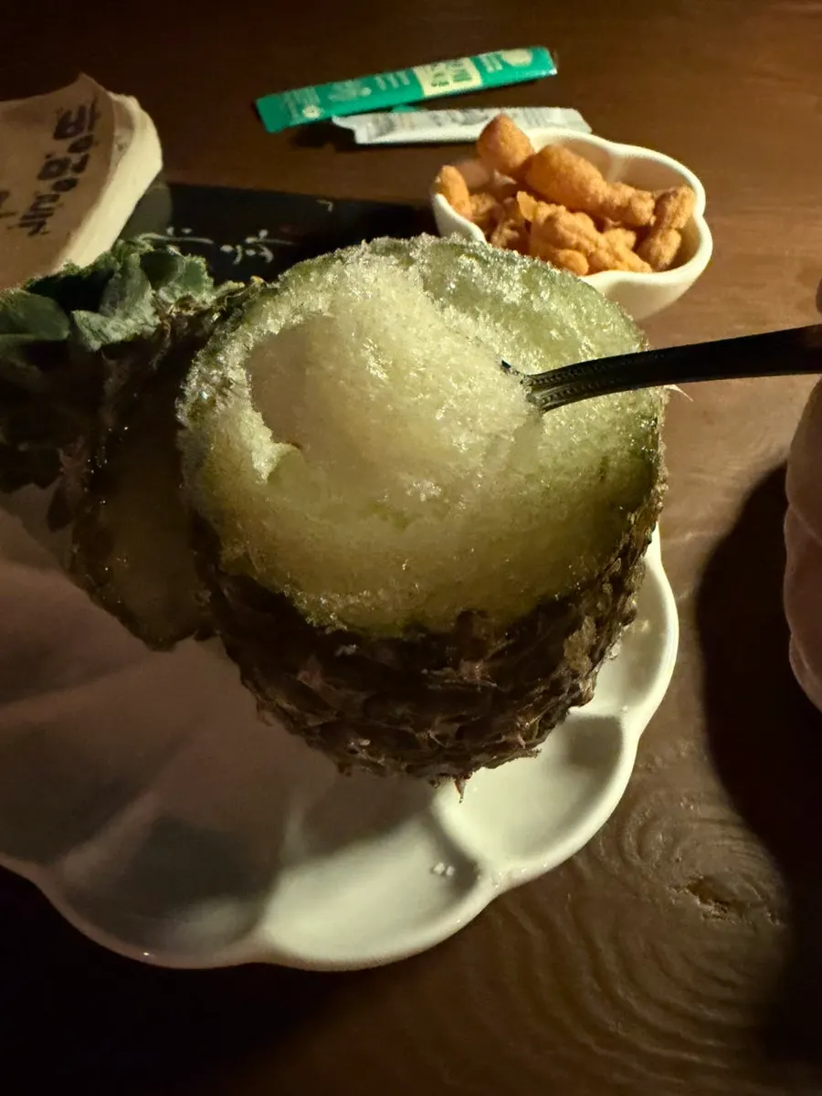 Scooping up pineapple sherbet with a spoon