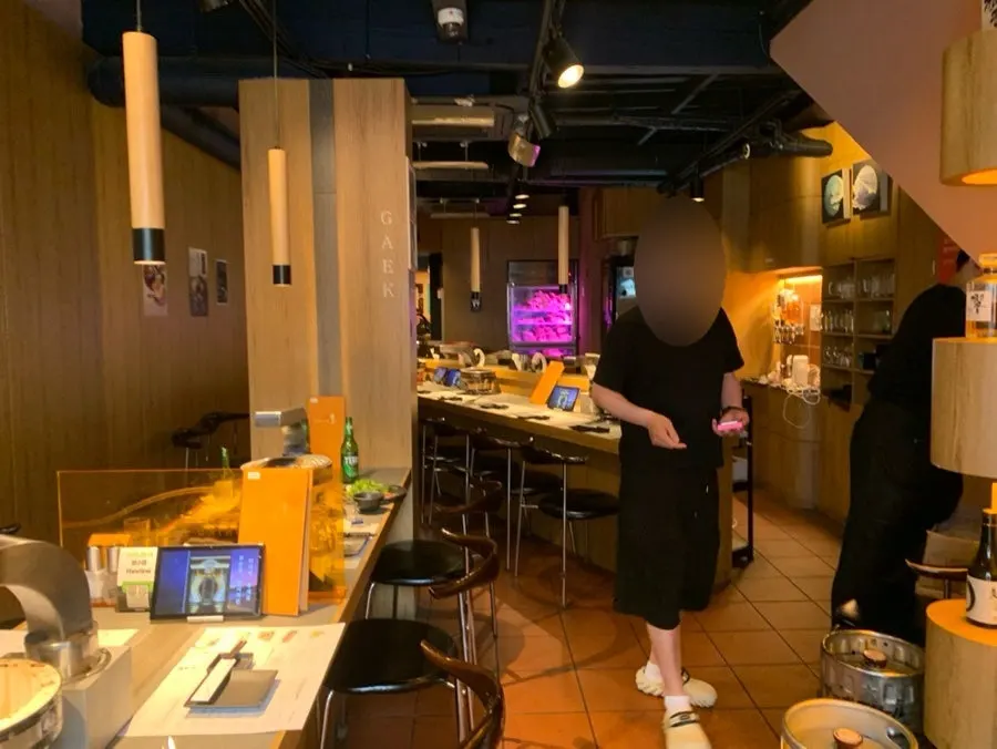 Interior of Yakiniku Gaek with 4-person tables and bar seating