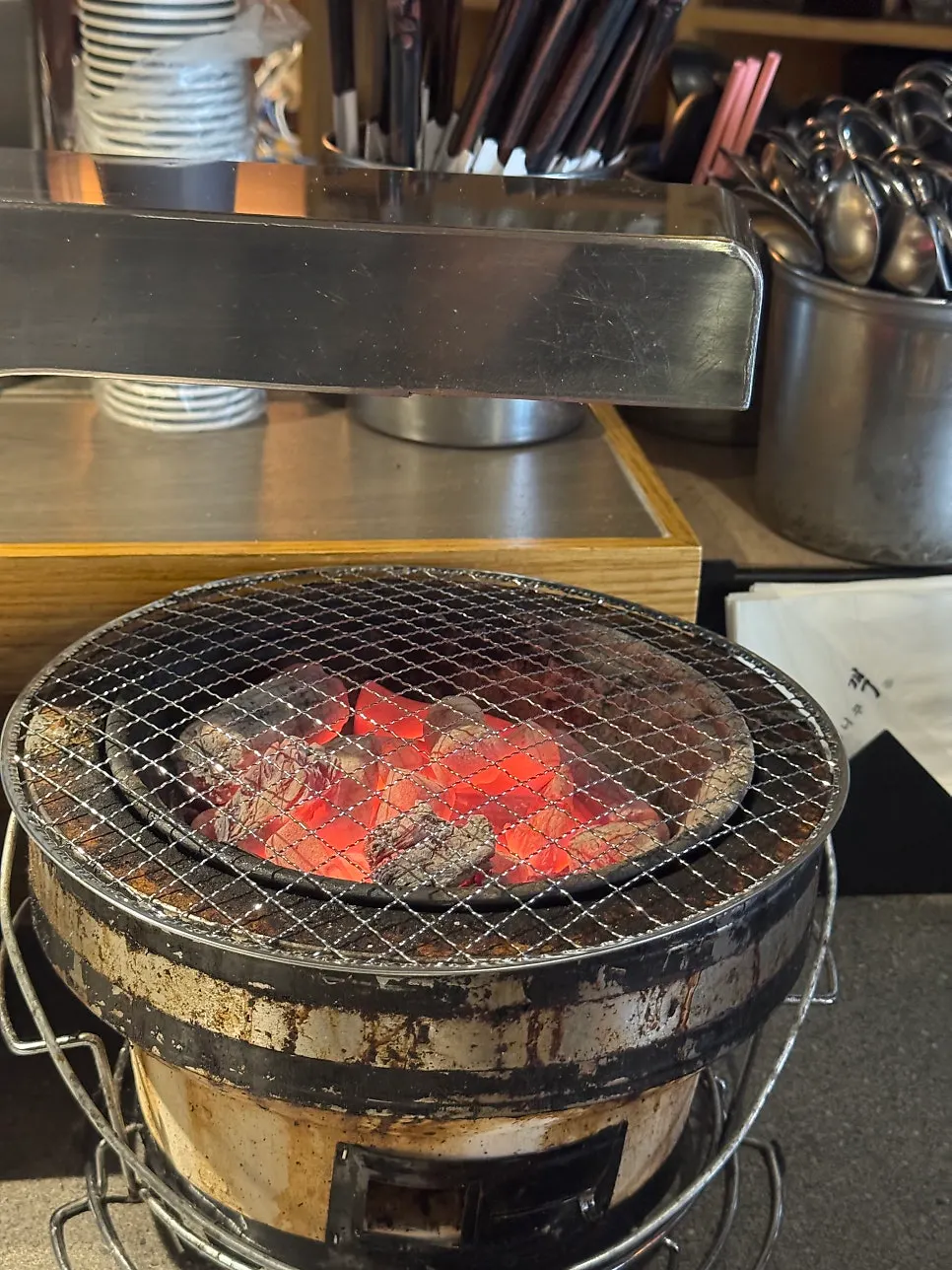 Personal charcoal grill set up on the table