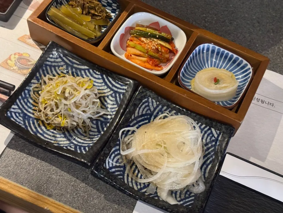 Side dish spread at Yakiniku Gaek including green onion kimchi