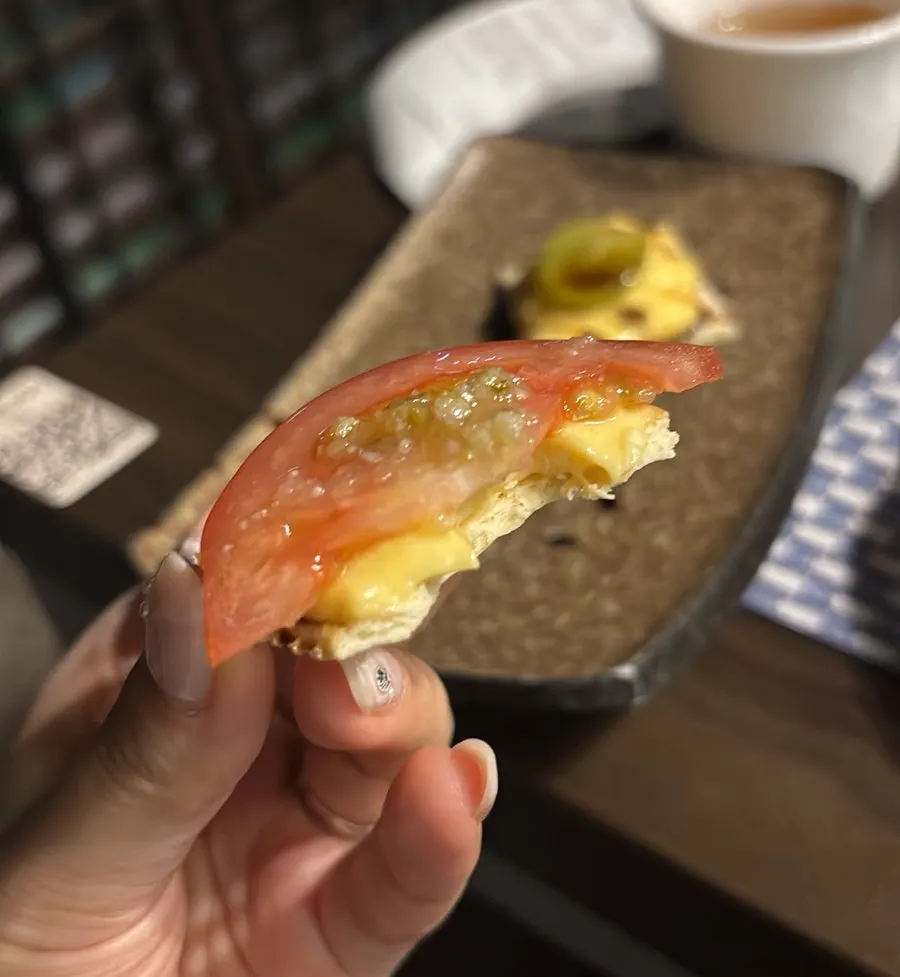 Cream cheese crackers topped with tomato