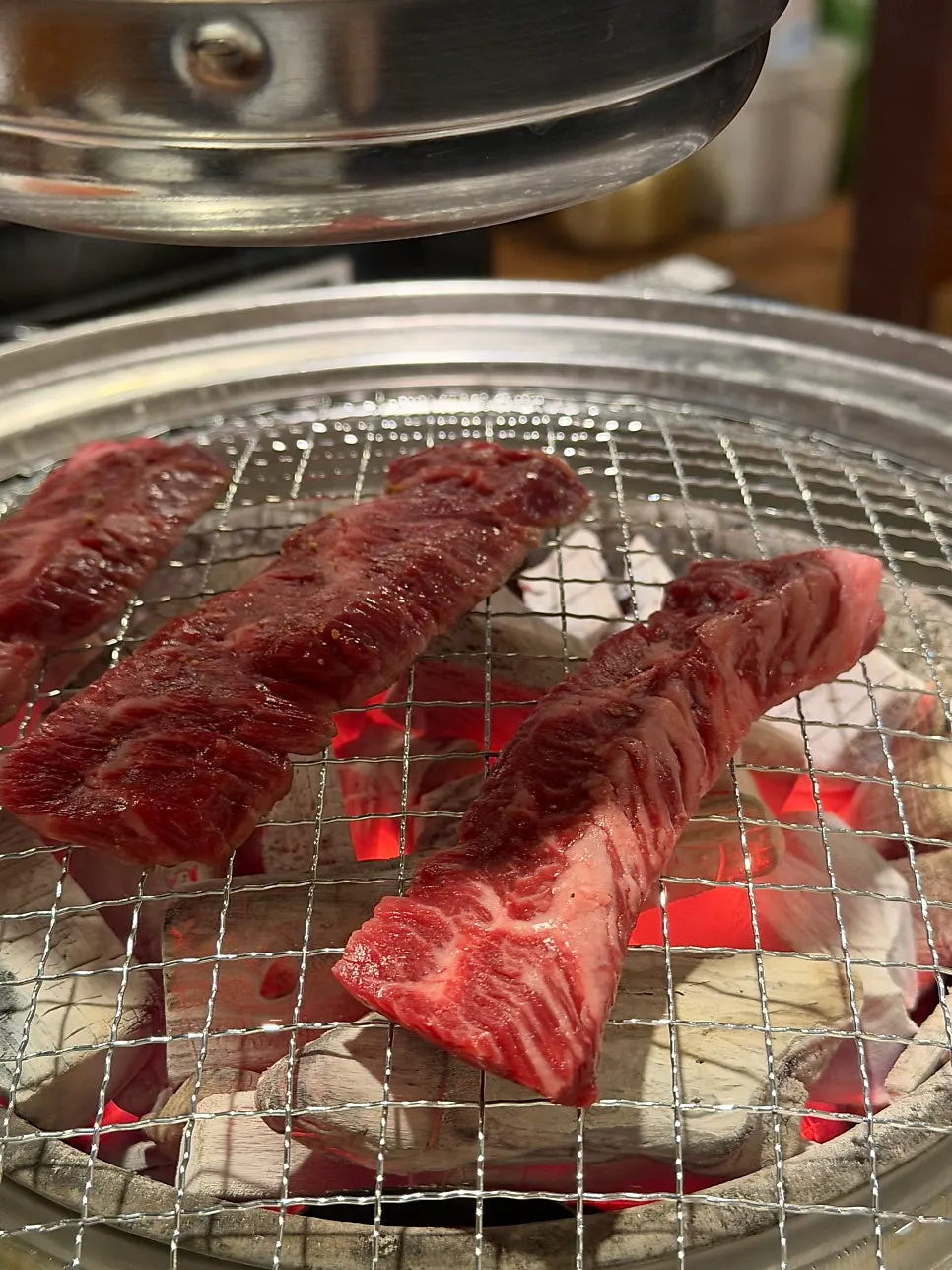 Skirt steak grilling over charcoal