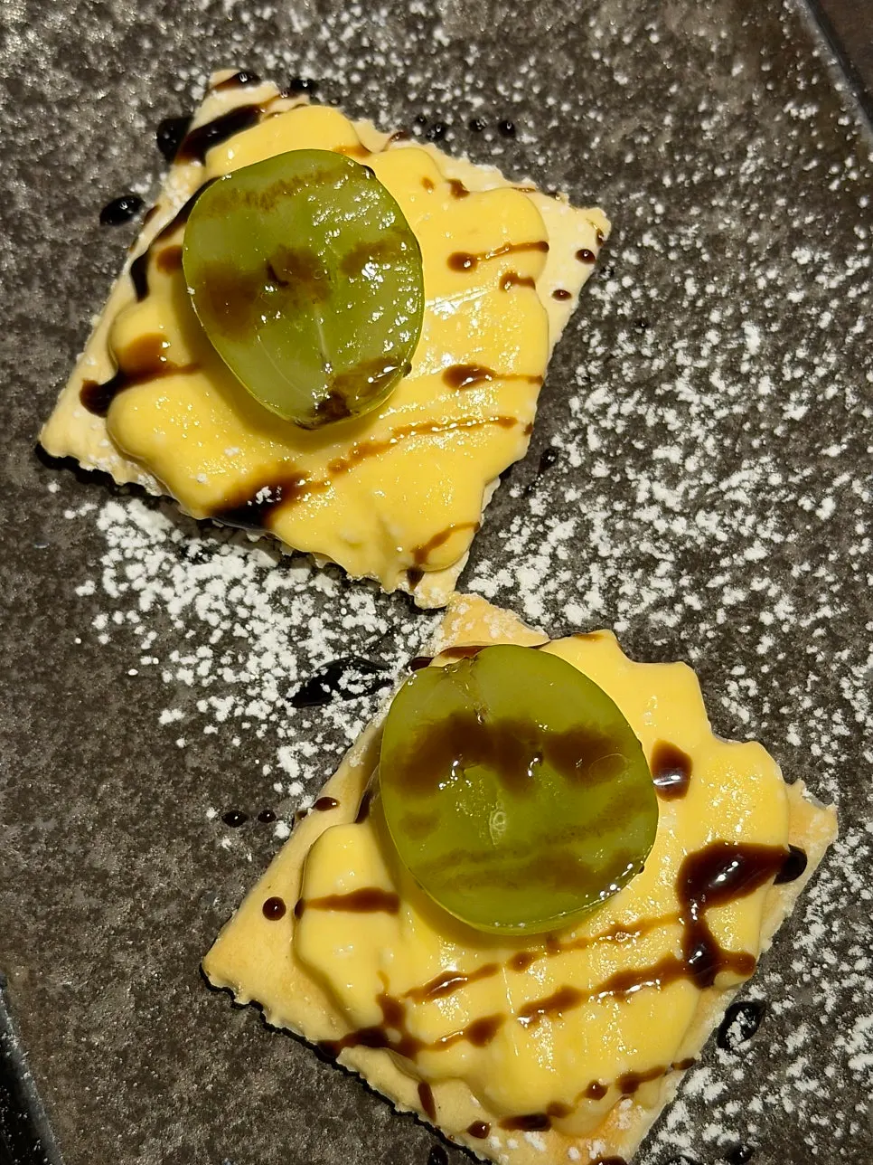 Complimentary canapé dessert topped with grapes and cream cheese