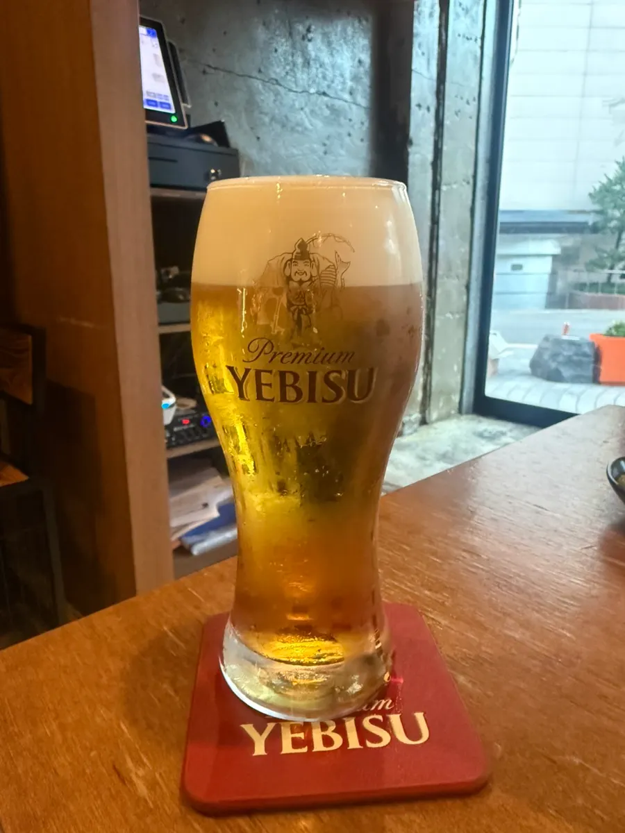 A glass of Yebisu draft beer that was ordered