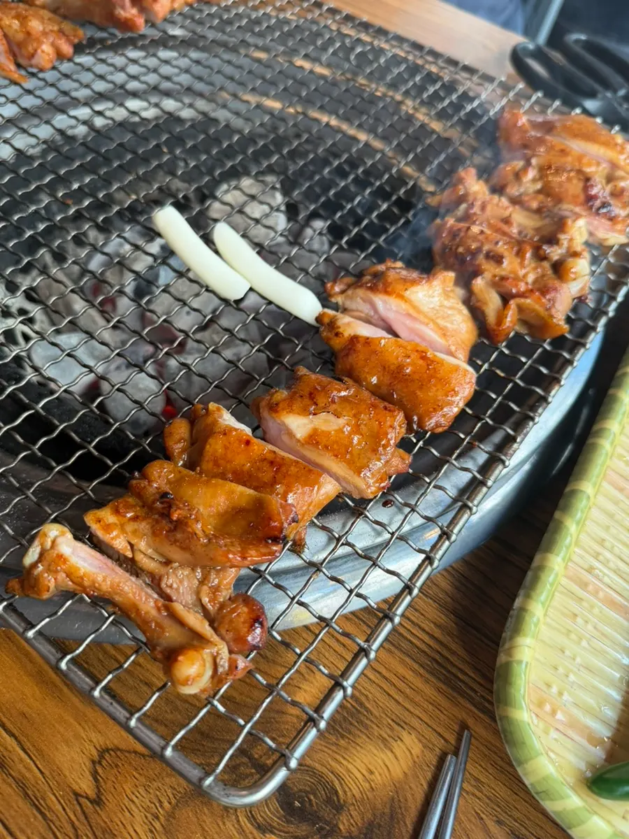 Dakgalbi grilling over charcoal