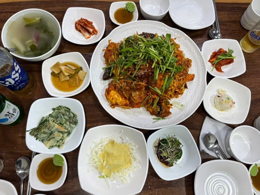 Banchan spread including water kimchi and savory pancake