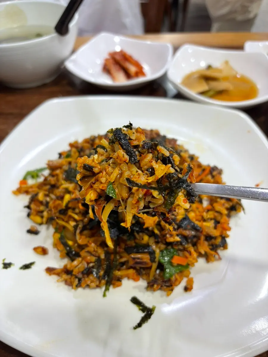 A spoonful of fried rice mixed with crispy rice bits