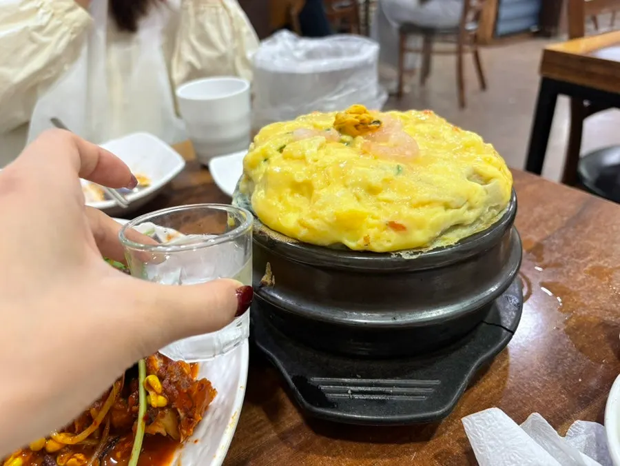 Giant egg custard compared in size to a soju glass