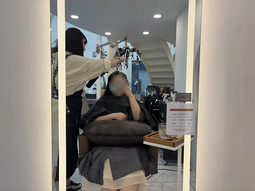 Checking the scalp condition at the crown and parting