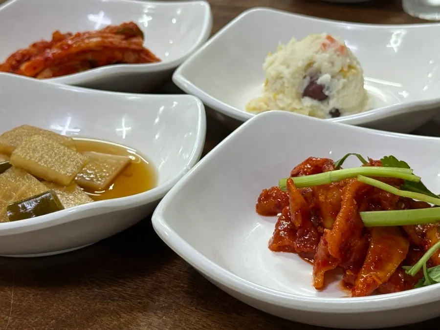 Table set with side dishes including potato salad