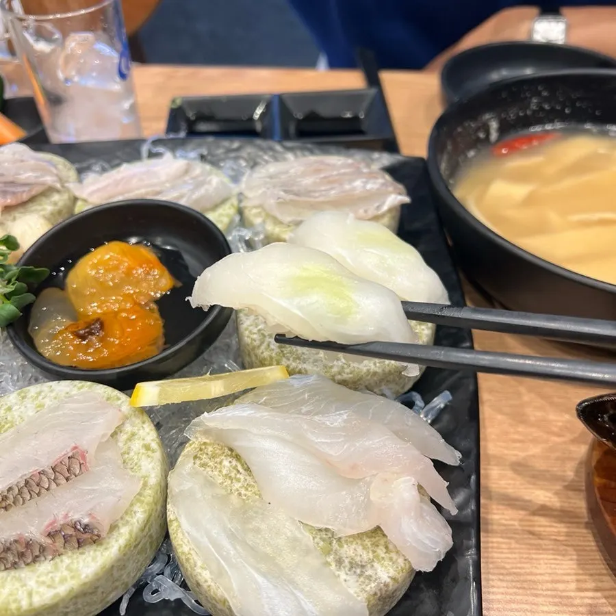 A piece of flounder wrapped in aged kimchi