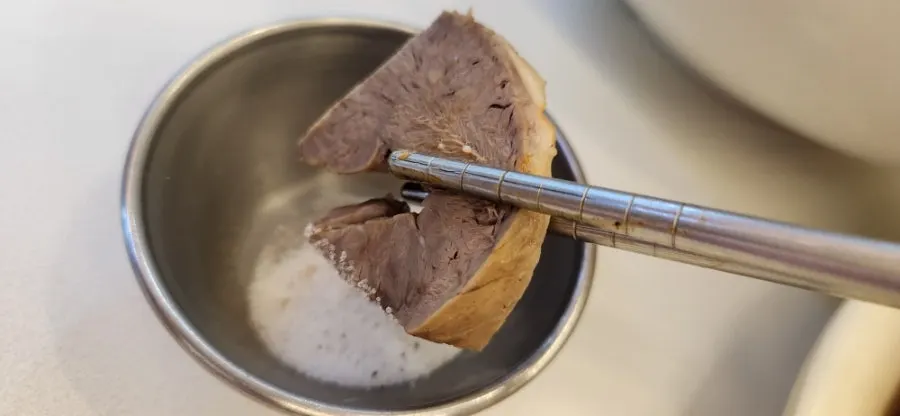 Chewy rice cake being picked up with chopsticks