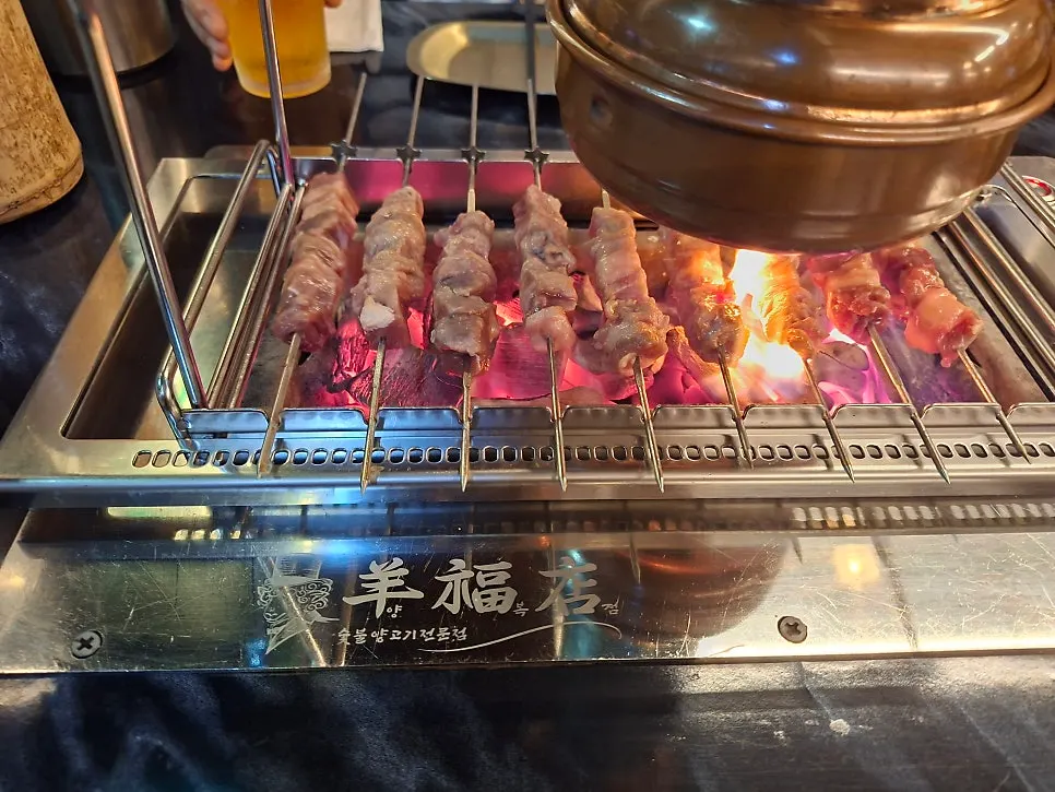 A cold glass of Cass beer enjoyed with lamb skewers