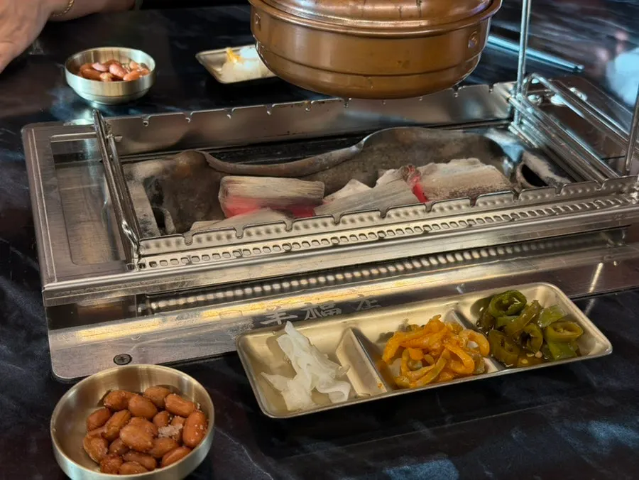 Table setting with peanuts and zha cai served with the skewers