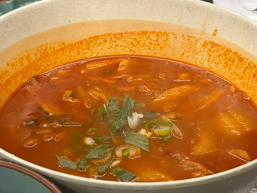 Springy noodles lifted out of the onmyeon broth