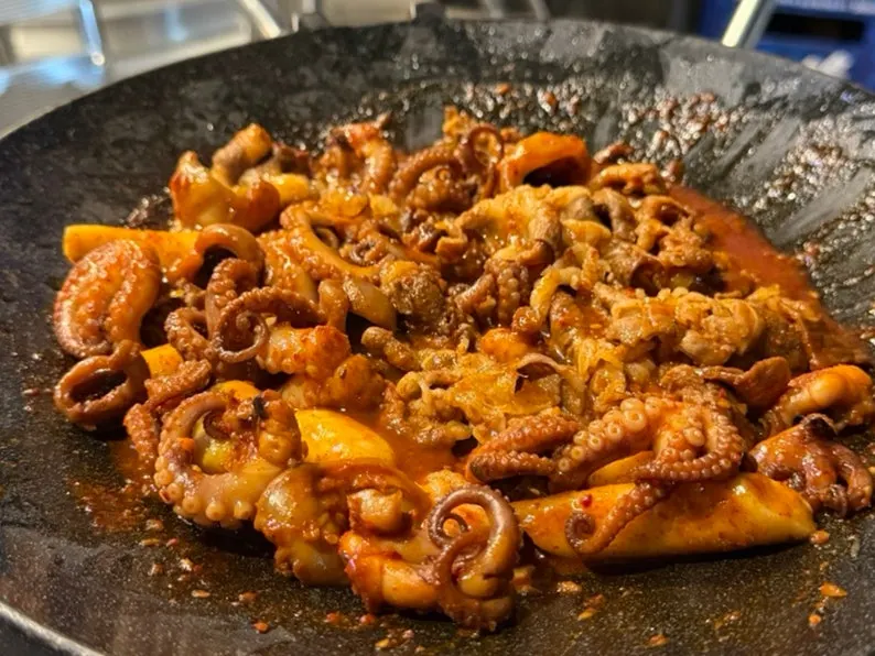 Webfoot octopus being cooked