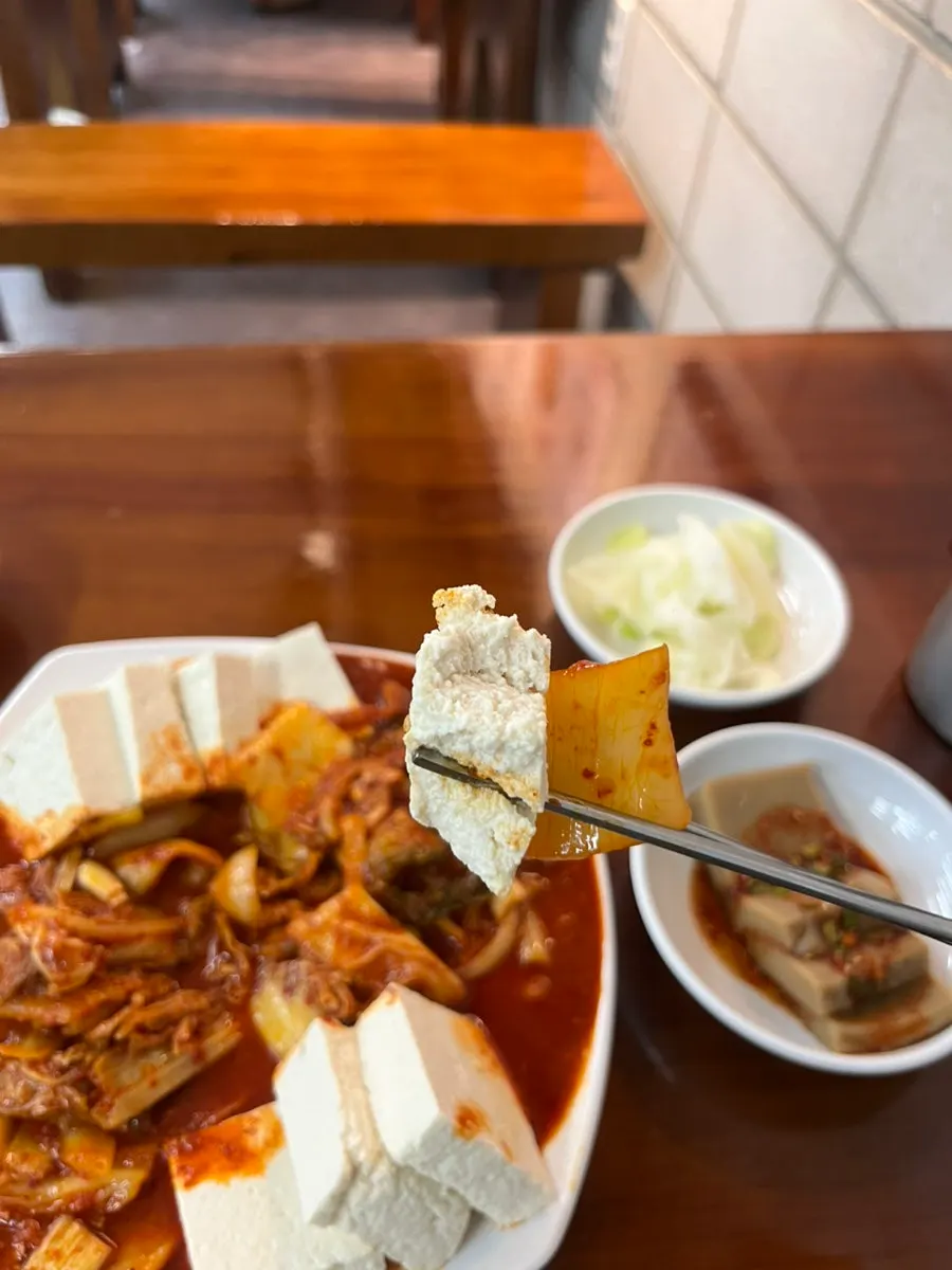A bite of firm tofu and kimchi