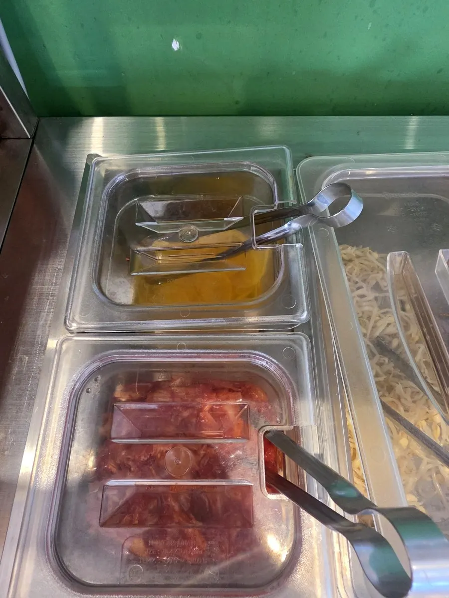Self-bar with side dishes like pickled radish and kimchi