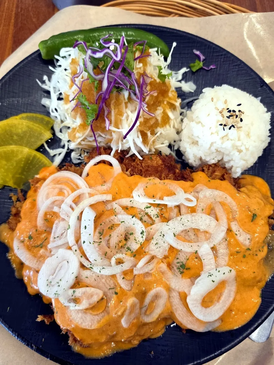 Rosé pork cutlet topped with rosé sauce and onion