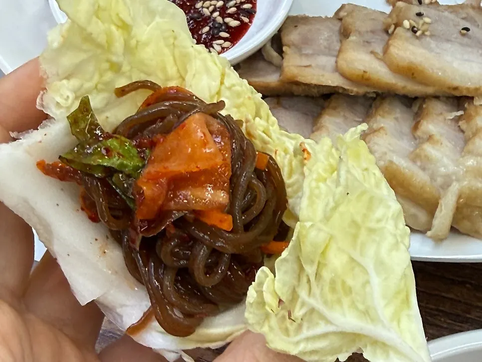 Bibim naengmyeon wrapped up in lettuce for a wrap-style bite