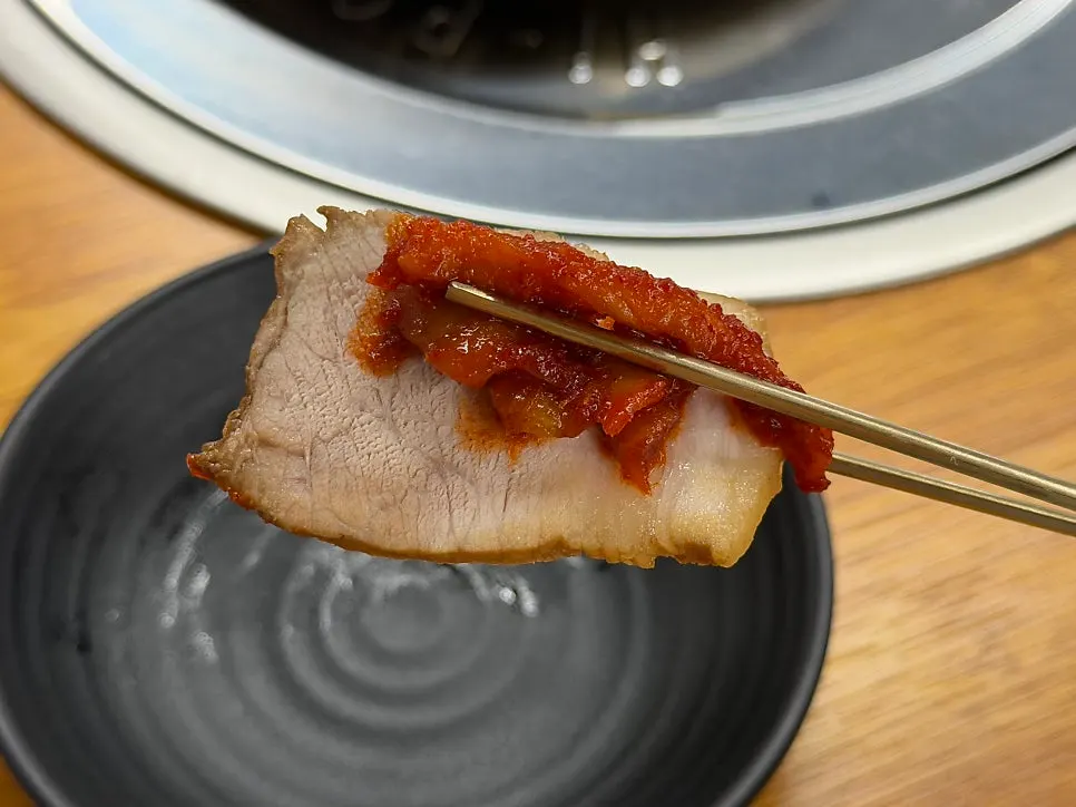Plate of myeongtaehoe suyuk with boiled pork, pollack sashimi, and bossam radish slaw