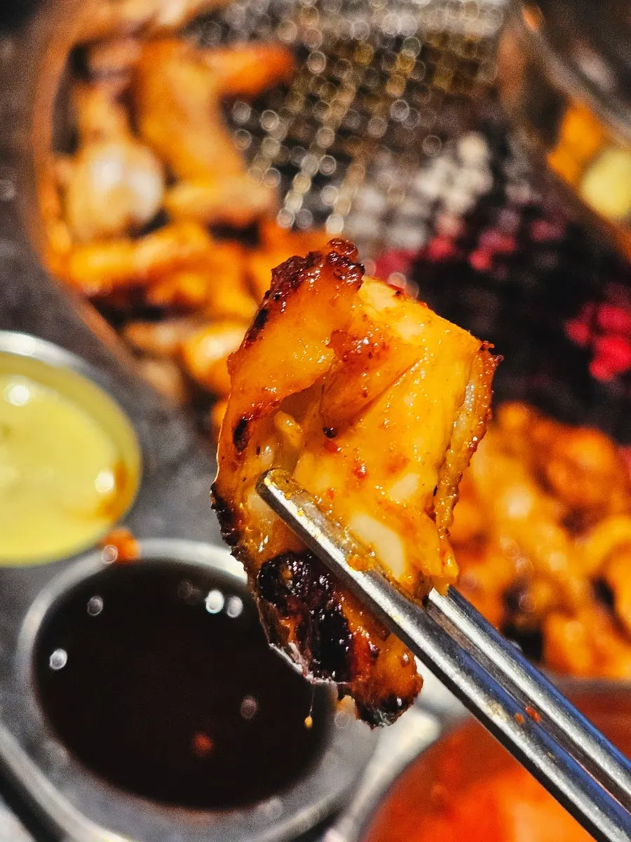 Grill plate with both salt and gochujang dakgalbi cooking together