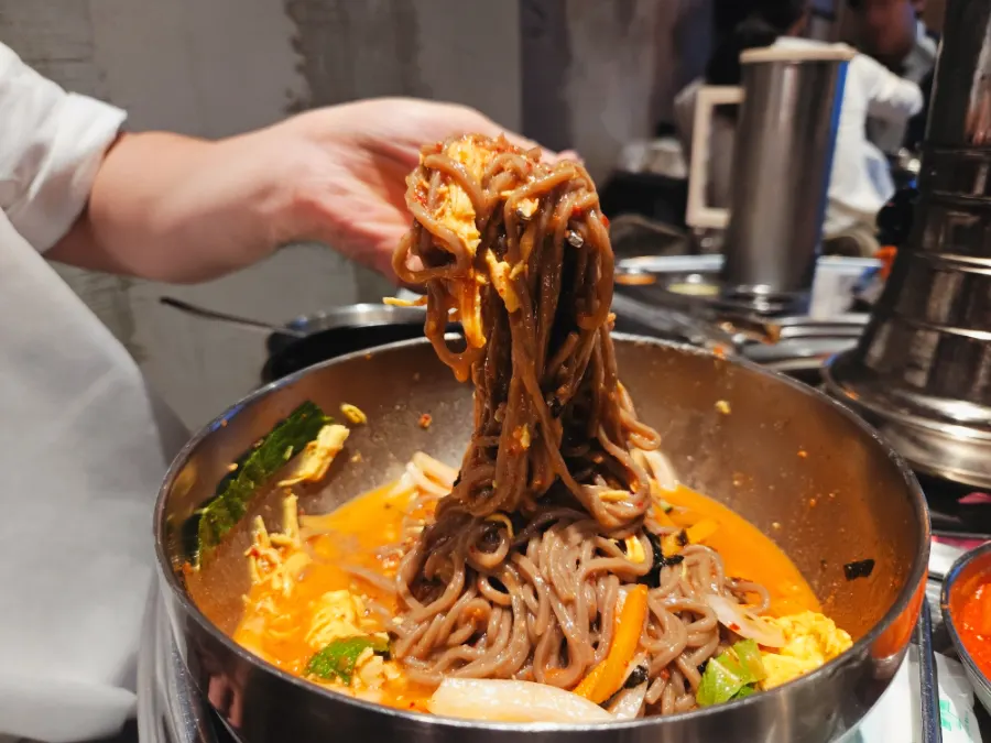 Bibim makguksu placed on top of dakgalbi