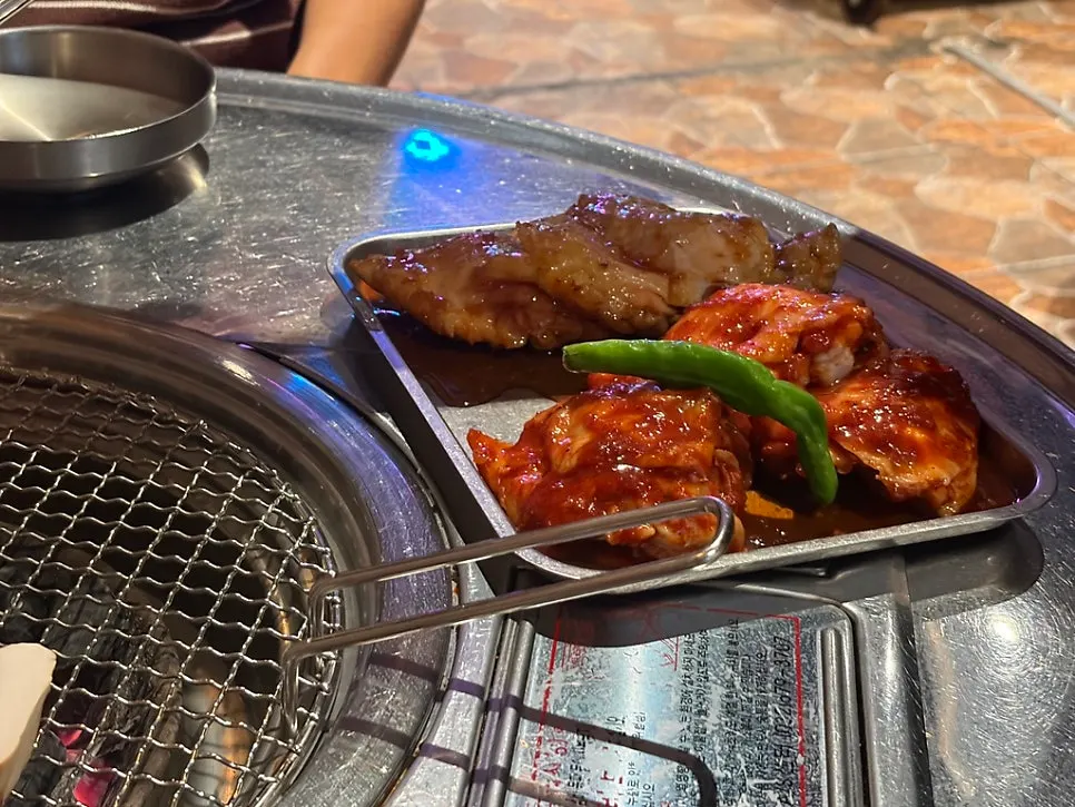 Raw 300g serving of charcoal dakgalbi on a plate