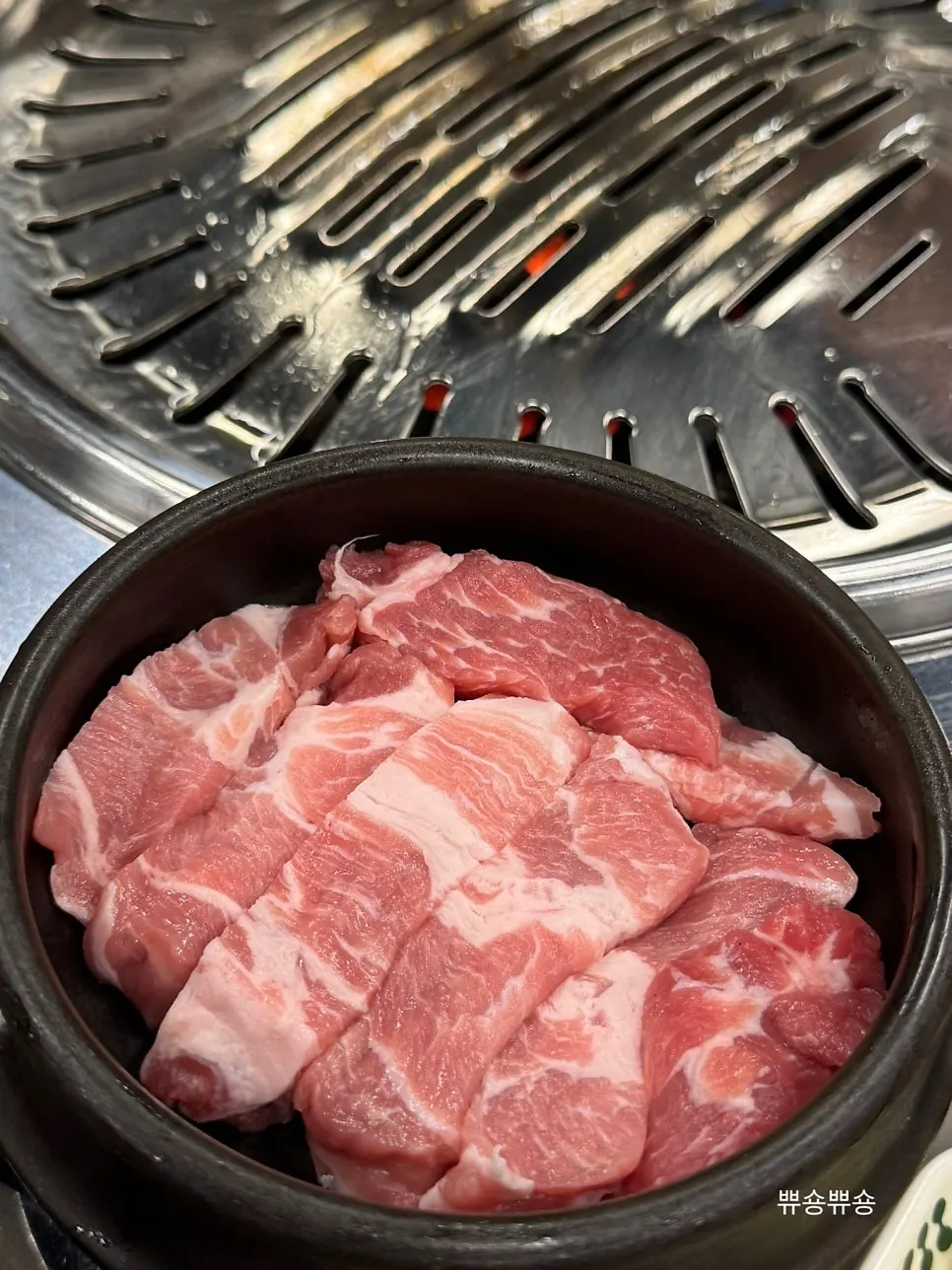 Meat grilling over charcoal