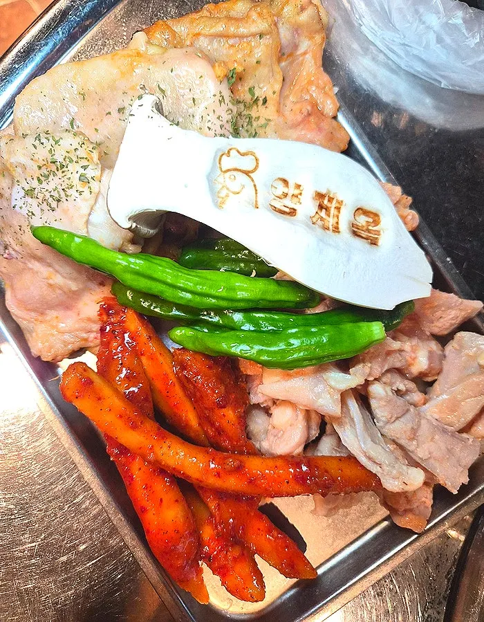 Assorted platter of salt dakgalbi, chicken cartilage, and grilled deodeok