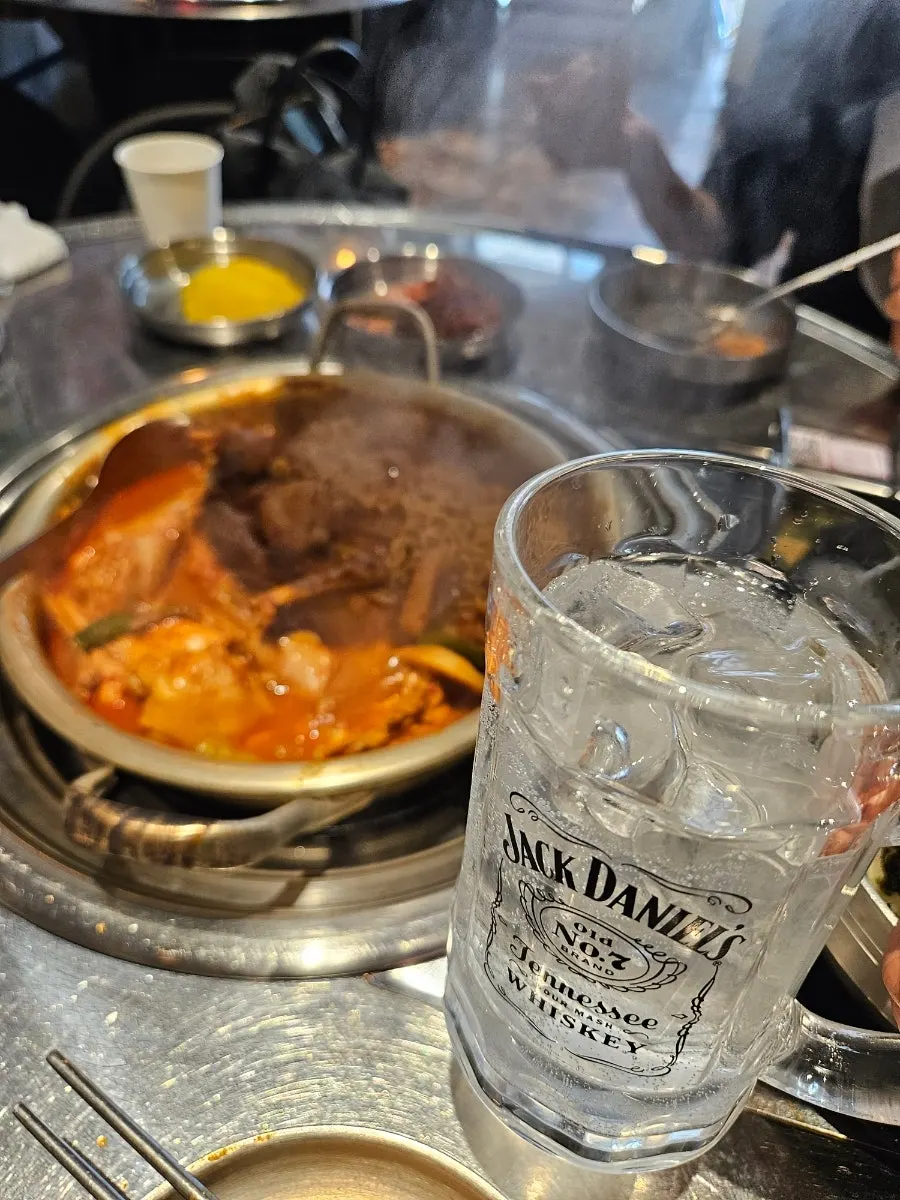 Glass of iced sprite next to the dakdoritang