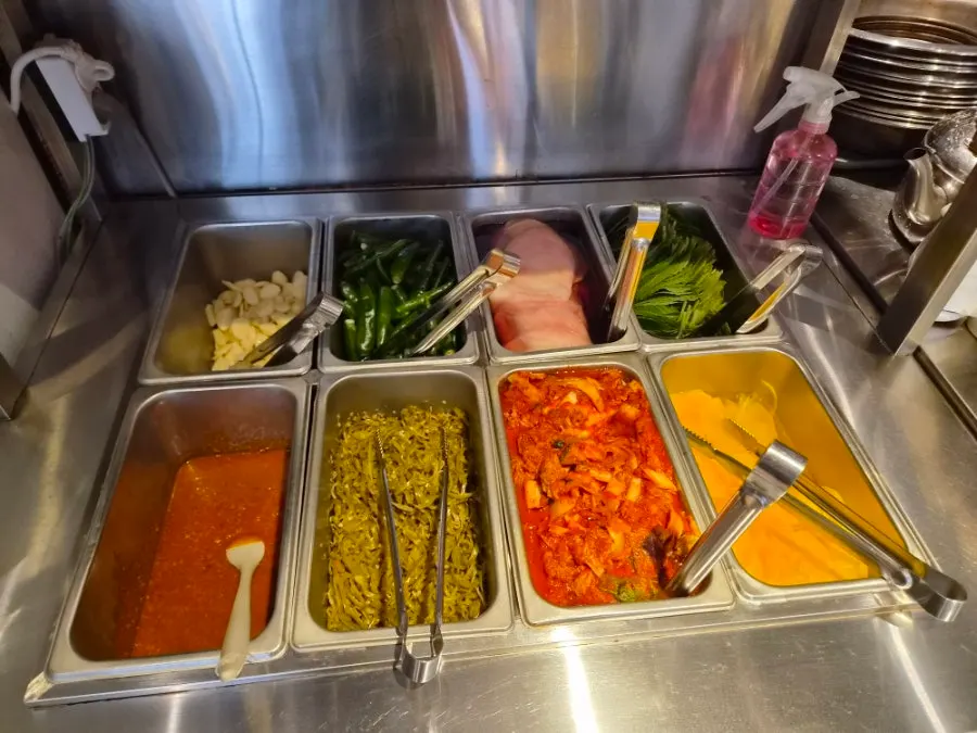 Neatly arranged side dishes at the self-serve bar
