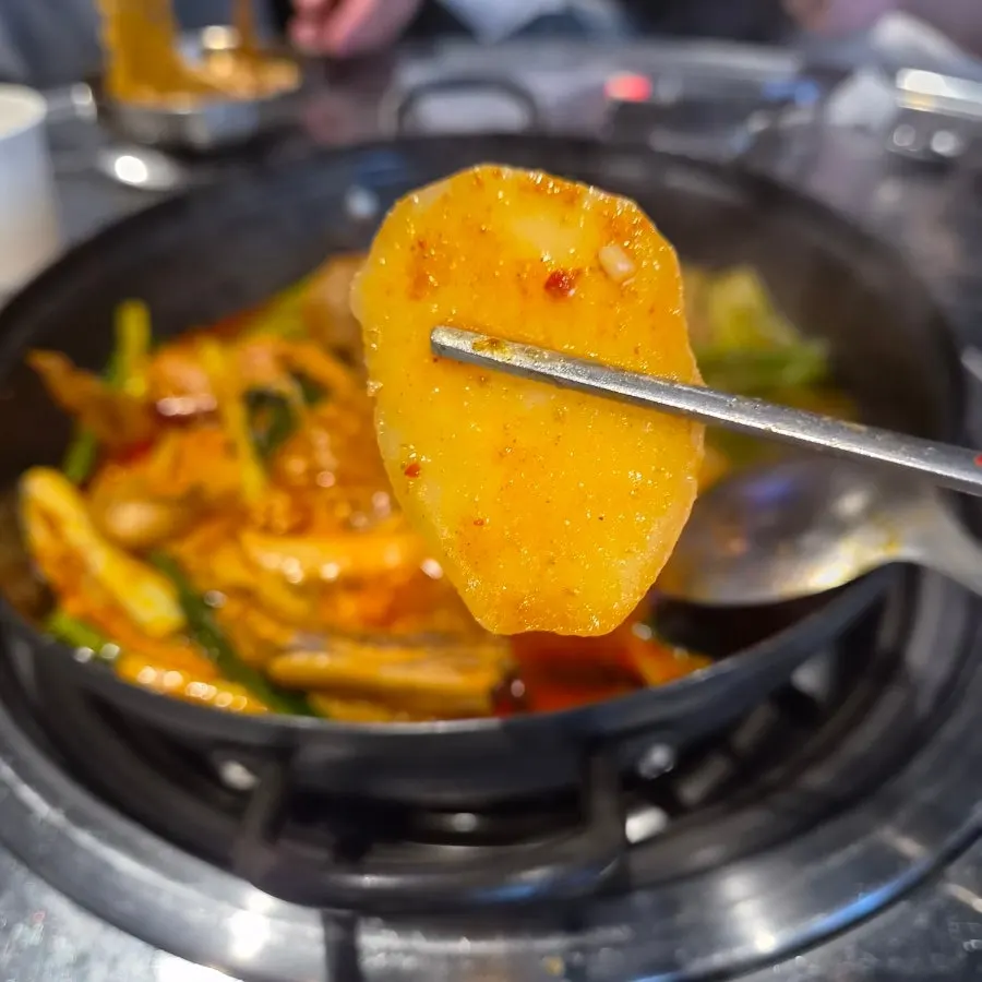 Fluffy potato and chewy rice cake sitting in the broth